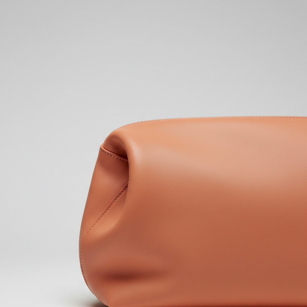 Classic Carry sculptural leather handbag in Coral Peach - leather detail close-up